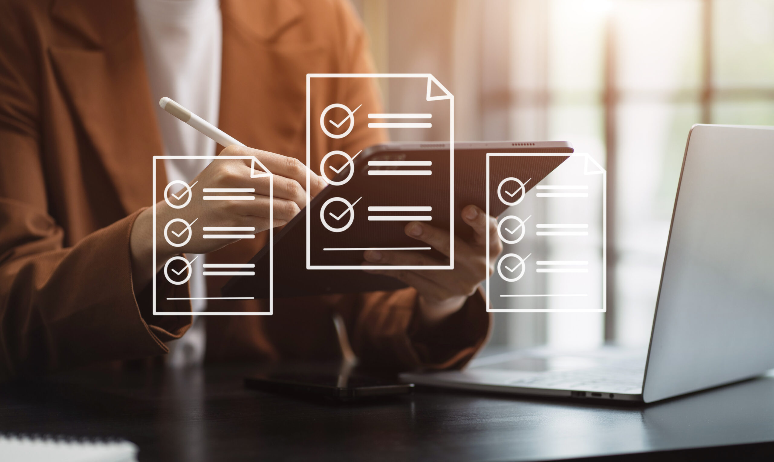 Woman working with digital text floating in front of a laptop