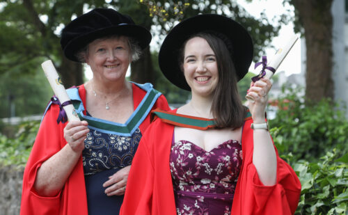 Two researchers pictured at their graduation