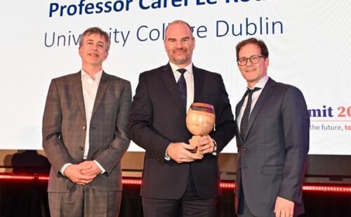IRC Director Peter Brown and IRC Chair Daniel Carey presenting a trophy to Professor Carel le Roux