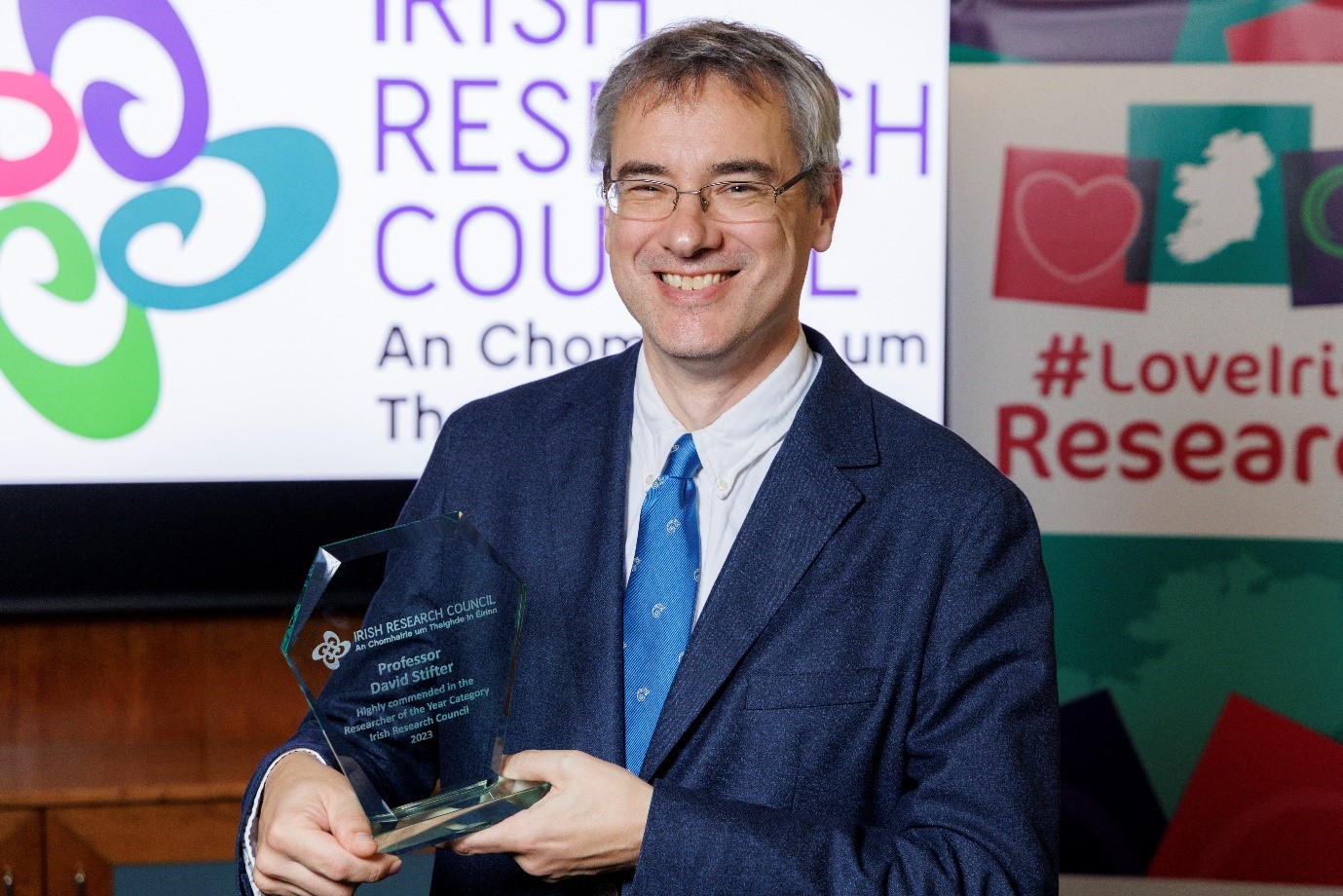 Professor David Stifter pictured holding a trophy