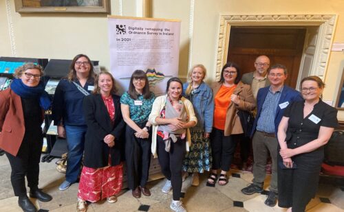 Group photo of OS200 launch , 8 people standing in front of banner